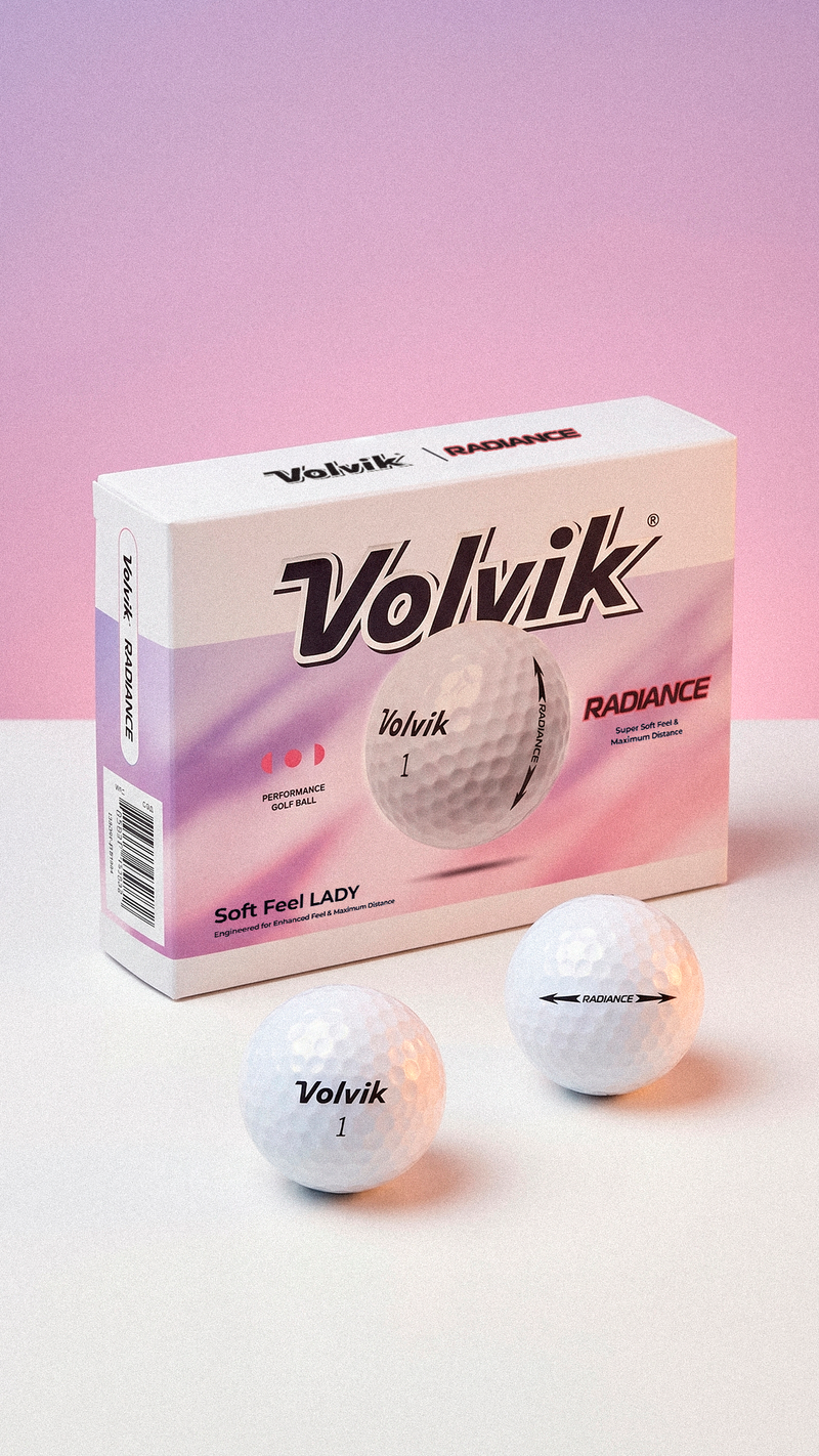 Volvik Radiance golf balls and packaging on a pink background