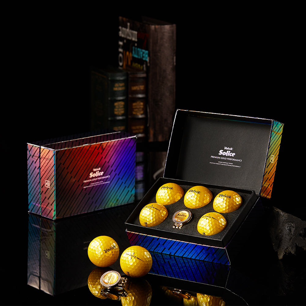Set of golf balls in a Volvik box with a dark background