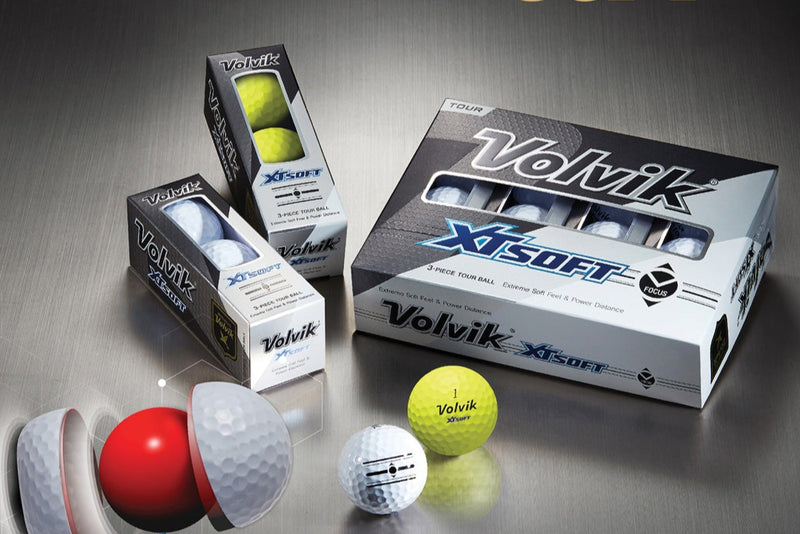 Volvik XT Soft golf balls and packaging on a reflective surface
