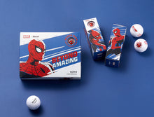 A set of golf balls with Spider Man design on the packaging, along with the text 'Beyond Amazing'. The packaging is blue and red, reflecting the Spider Man theme.
