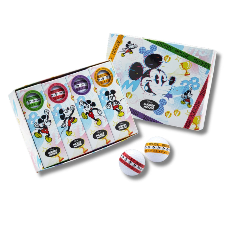 A set of dozen golf balls with Disney Mickey Mouse characters design, along with golf tees and packaging, displayed on a grass-like surface.
