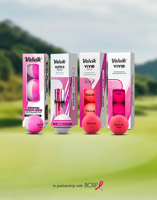 Packaging of Volvik golf balls in pink with a blurred golf course background