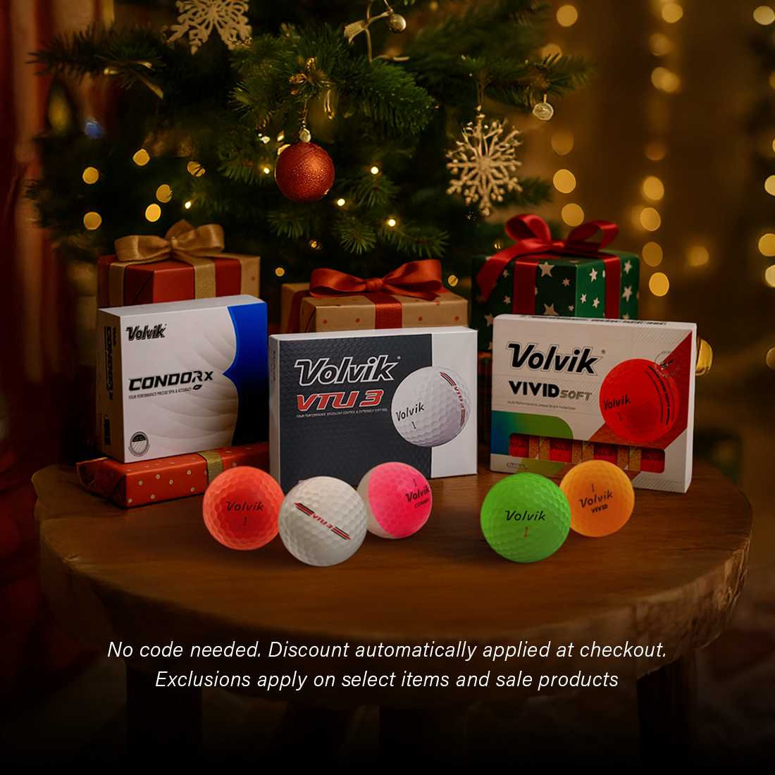 Volvik golf balls and packaging on a table with Christmas tree and presents in the background