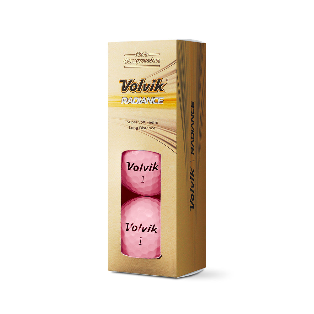 Volvik Radiance golf balls packaging with pink golf balls on a beige background