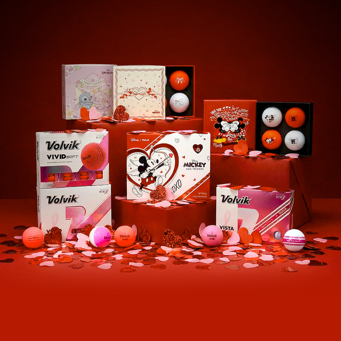 Collection of Volvik golf balls and packaging on a red background