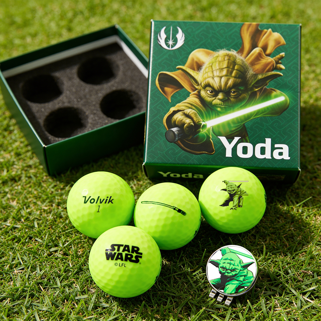 Yoda-themed golf balls and packaging on grass