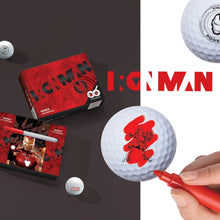 A collection of golf balls with Iron Man designs, a box of golf balls, and a magic marker pen.